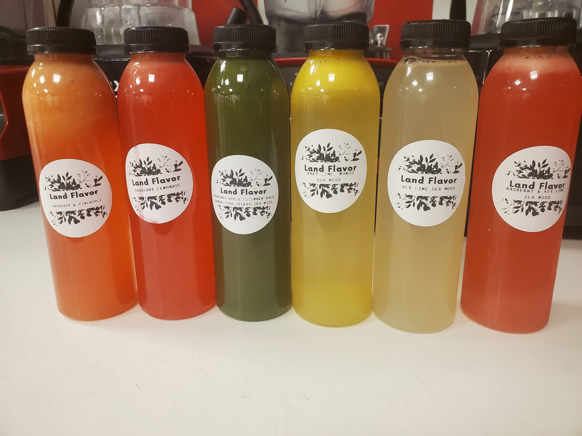 Row of Land Flavor cold-pressed juice bottles